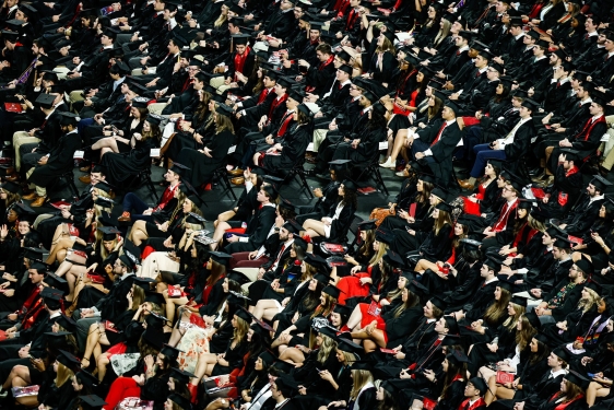 photo of seated people in caps and gowns